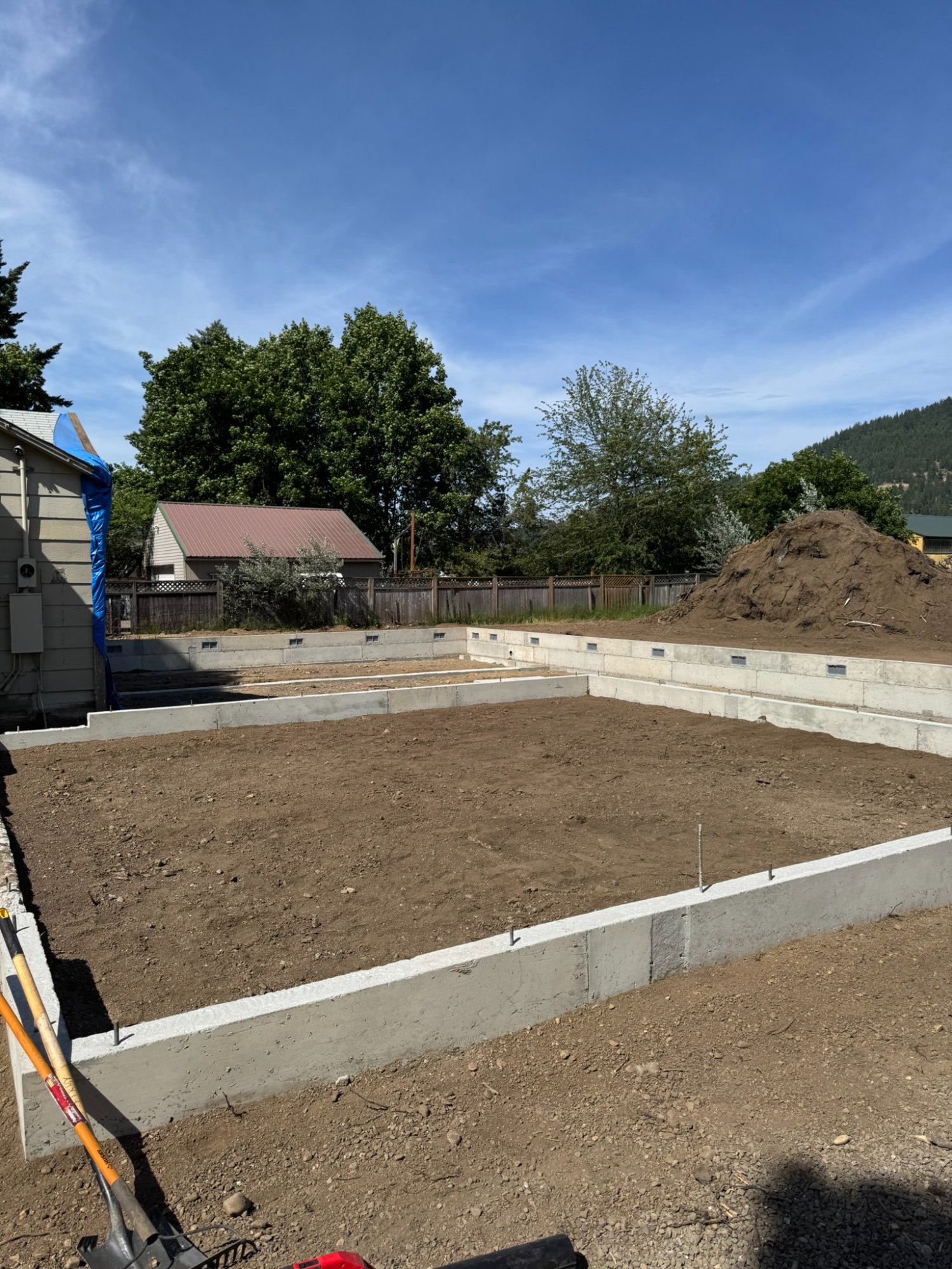 Elkry Construction CAT excavator working on lakeside excavation project in North Idaho