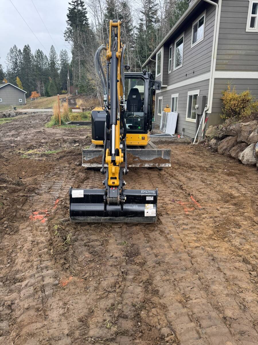 CAT excavator during residential site preparation in North Idaho by Elkry Construction