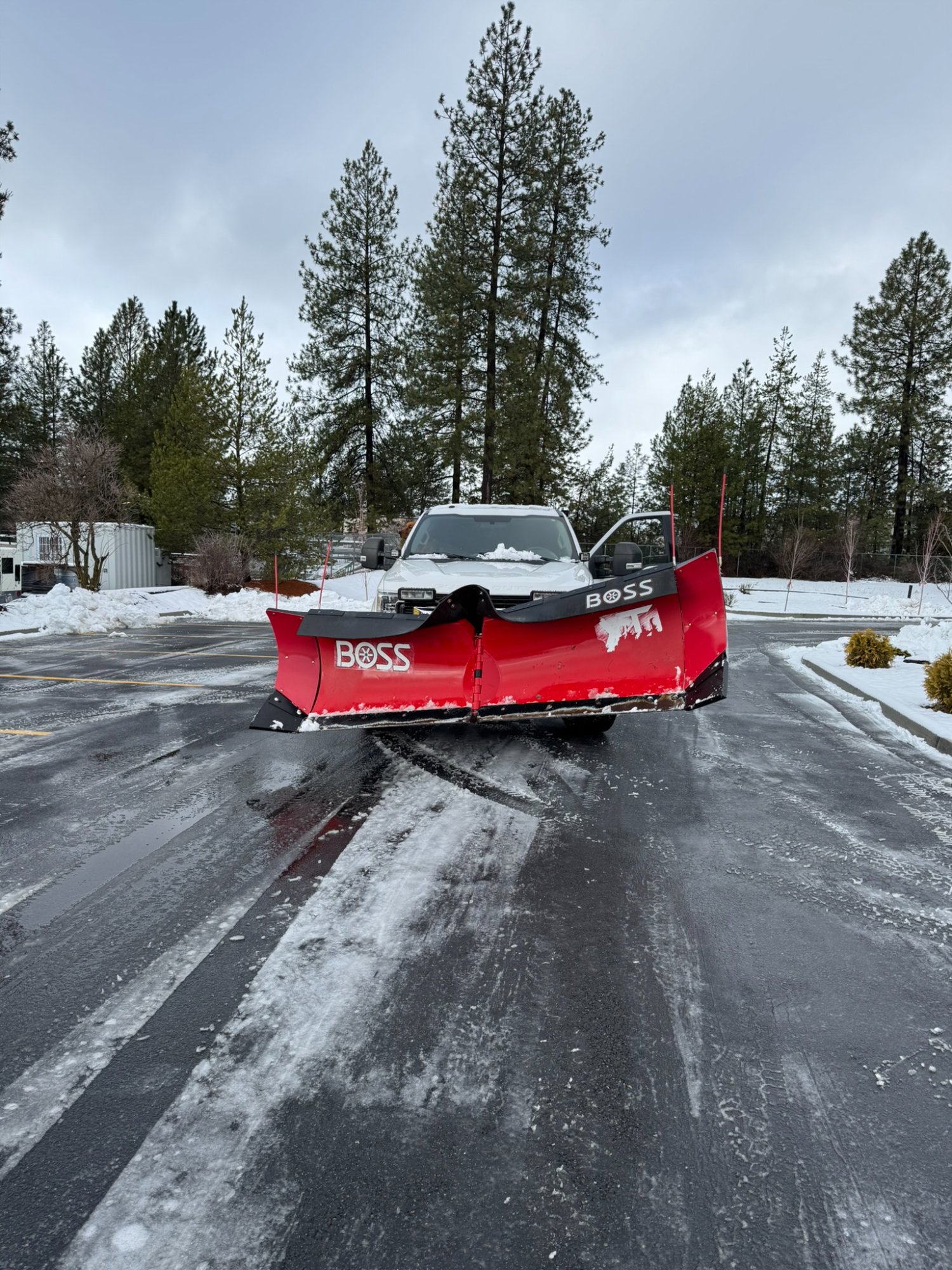 Elkry Construction BOSS plow truck clearing commercial parking lot in Coeur d'Alene Idaho