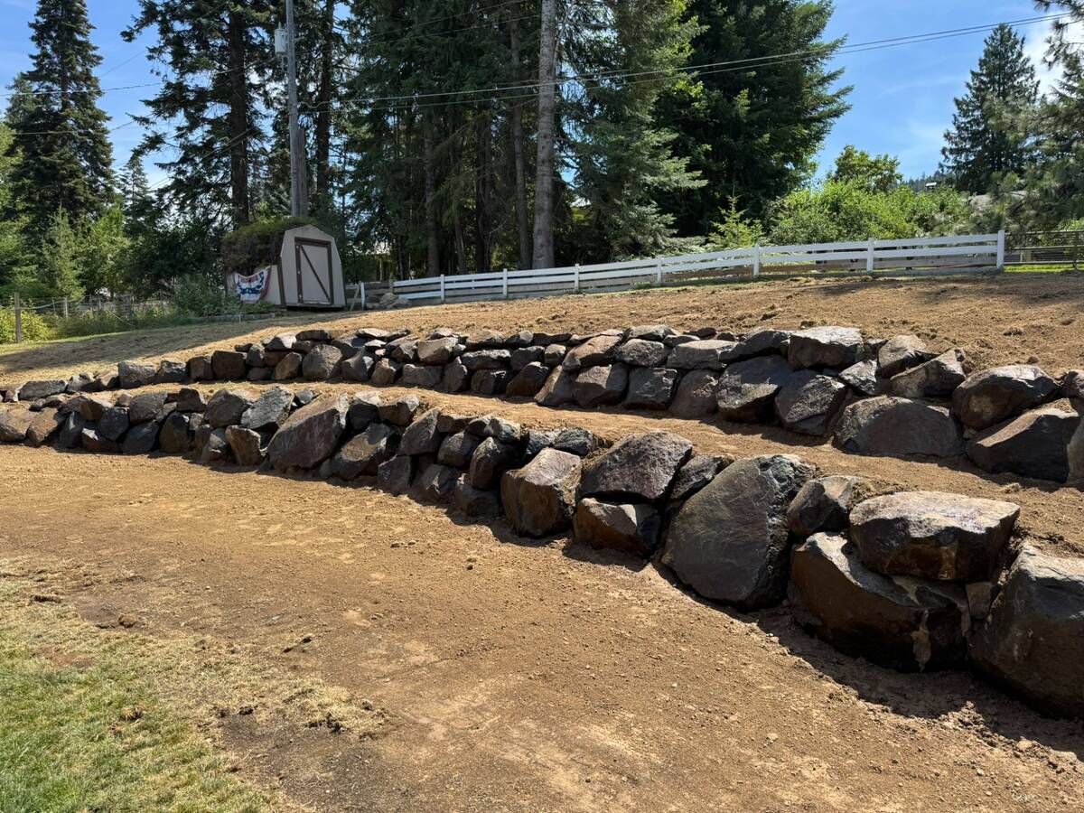 Completed rock retaining wall at residential property in Coeur d'Alene Idaho by Elkry Construction